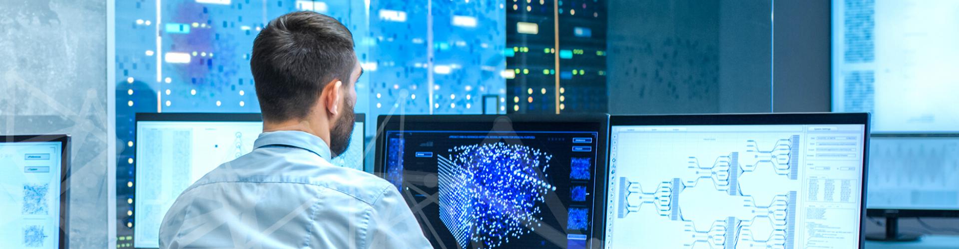 Researcher sitting at computer in computer lab