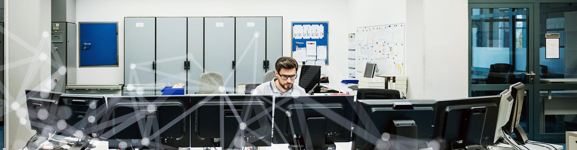 Researcher sitting at computer in computer lab