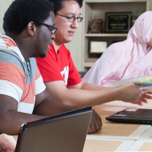 Honors College students working together in front of a laptop computer