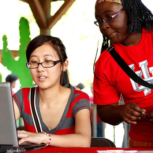 student and mentor at coding camp