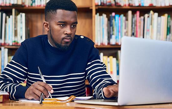 student studing at laptop in the library