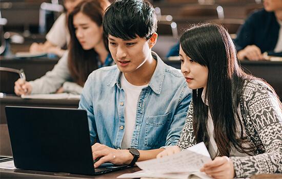 two students working on a classroom project